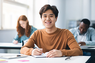 Male student sitting in class