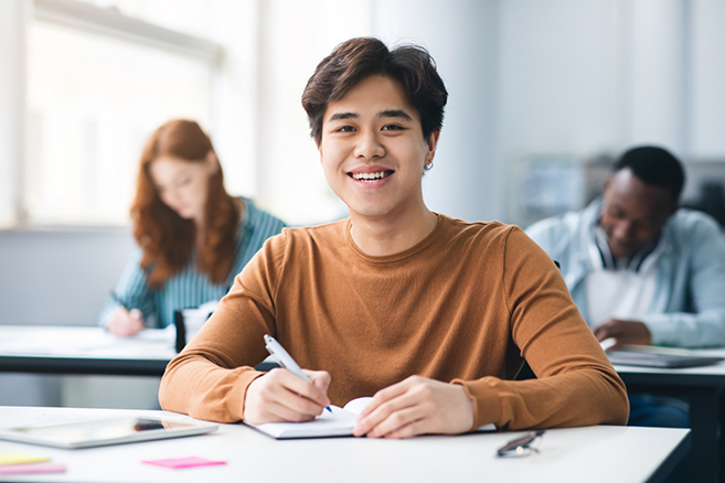 Male student sitting in class