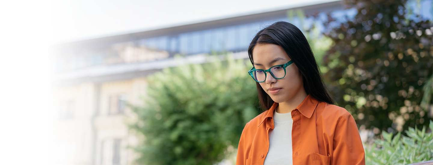 Student outside working studying alone