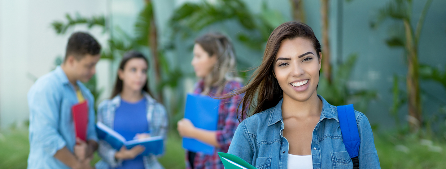 Students outside happy smiling