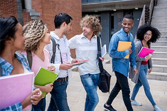 Students outside holding books