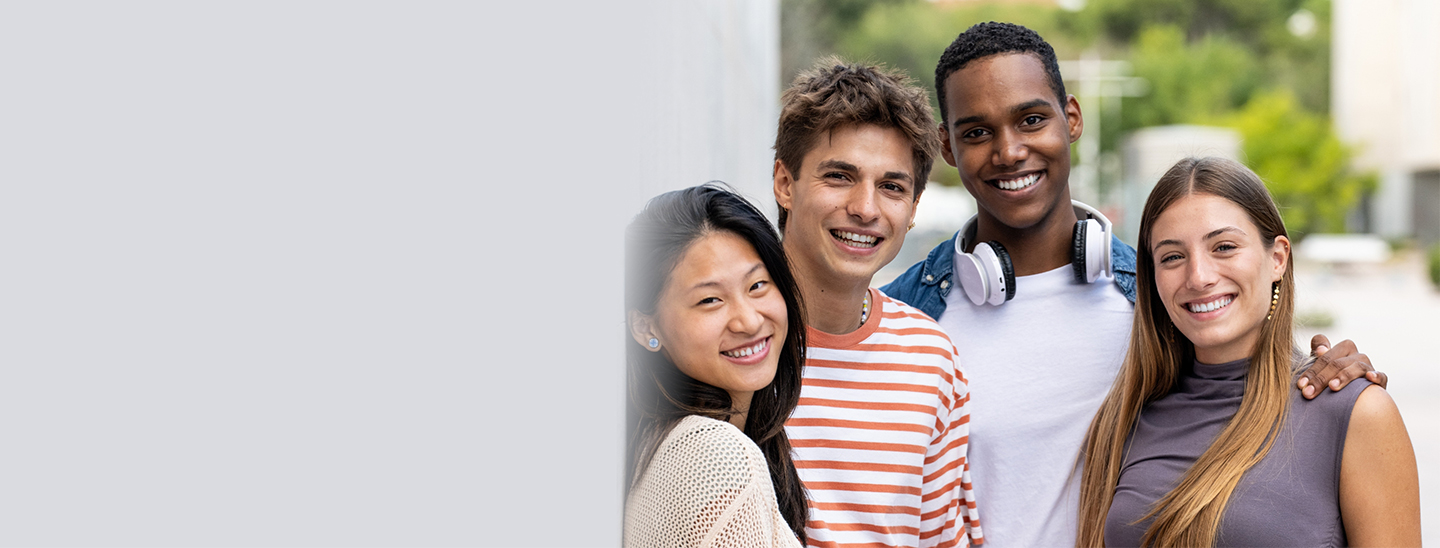 Students outside together smiling