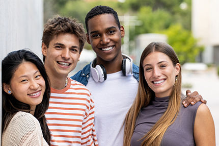 Students outside together smiling