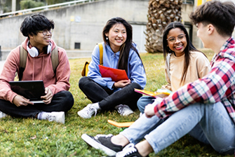 Students sitting on ground outside