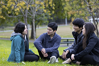 Students sitting on ground together