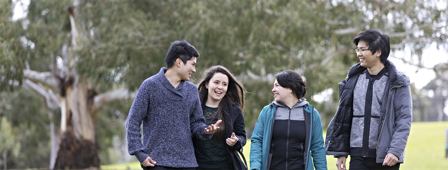 Students walking outside happy together